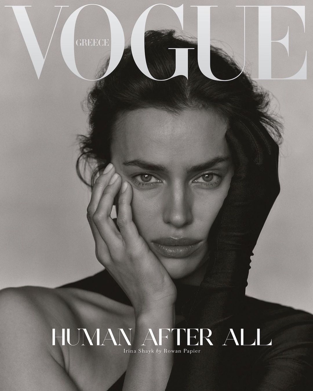Vogue Greece cover featuring Irina Shayk in a black and white portrait with her hand near her face and wearing a black glove.