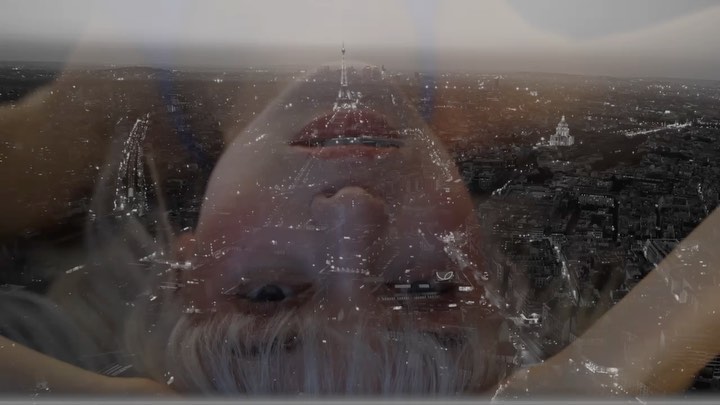 Double exposure photograph of a woman's face overlaid with an aerial view of Paris at night by photographer Rui Faria.