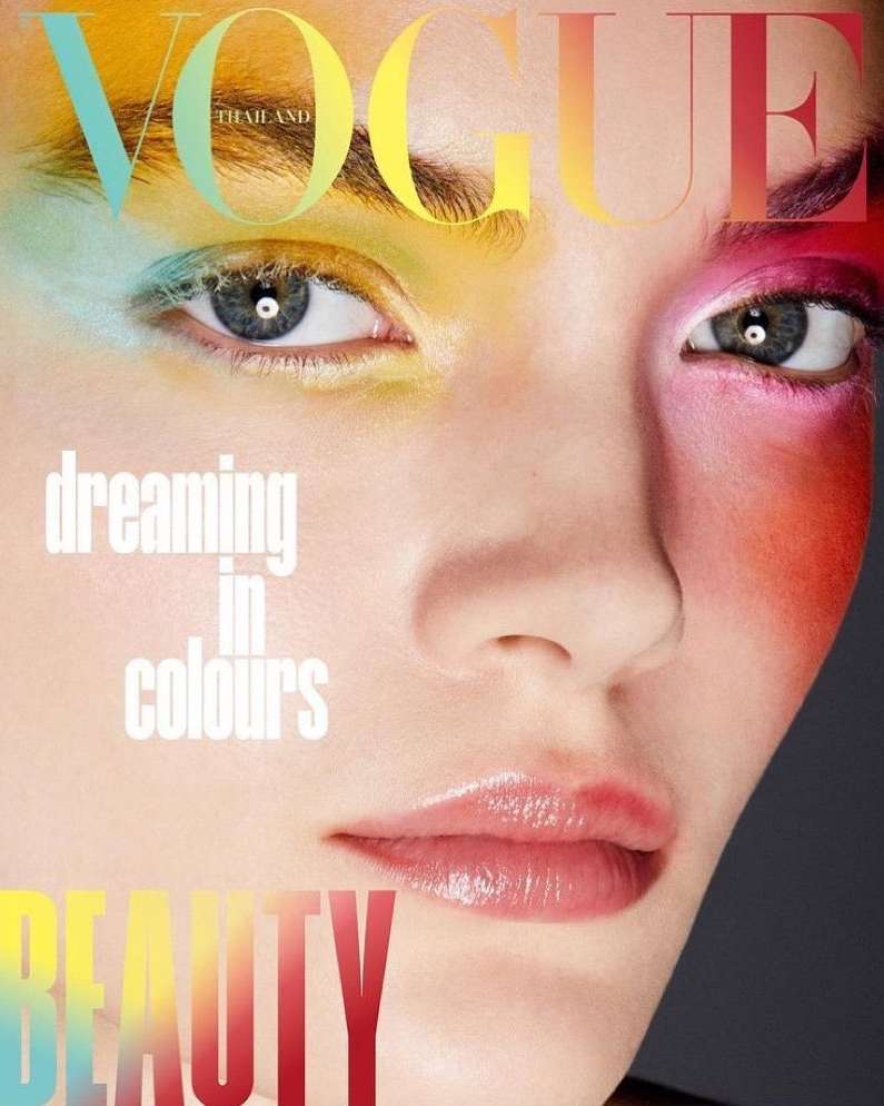Close-up of a woman's face with colorful makeup, featuring the Vogue Thailand magazine logo, and the word 'Beauty'.