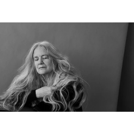 Monochrome portrait of an older woman with long flowing hair and closed eyes photographed by Ruven Afanador