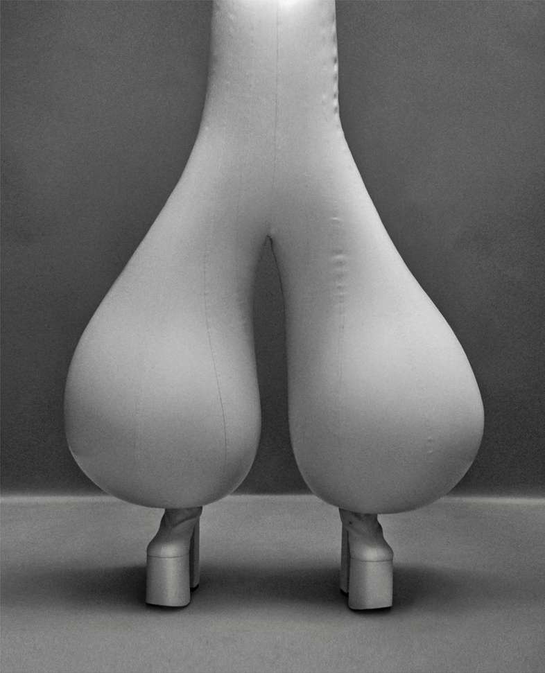 Unique balloon pants with platform boots stand out in a studio setting, emphasizing avant-garde fashion and contemporary design.