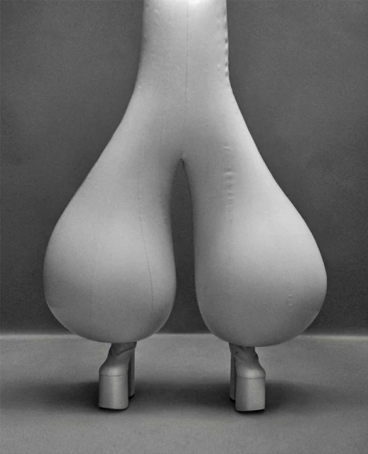 Unique balloon pants with platform boots stand out in a studio setting, emphasizing avant-garde fashion and contemporary design.