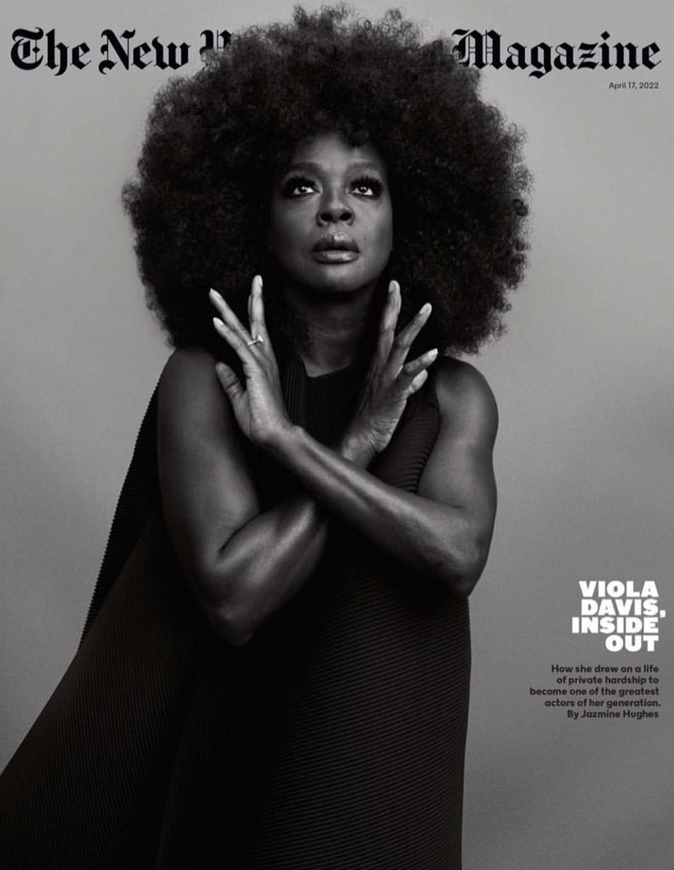 Magazine cover featuring Viola Davis with large afro, wearing a black dress, hands crossed, against a grey background.