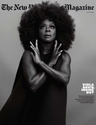 Black and white portrait of Viola Davis with large afro hair and crossed hands photographed by Ruven Afanador