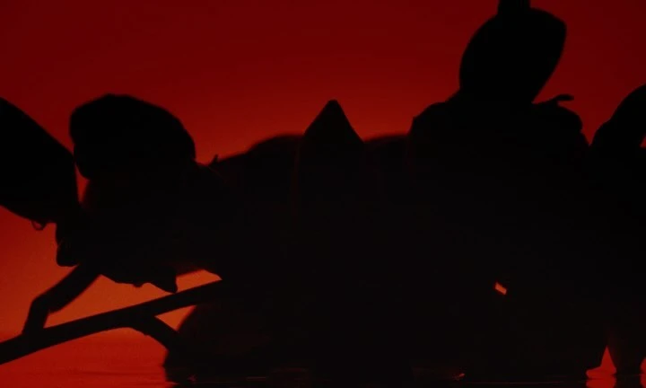 Silhouetted figures engaged in synchronized water sport against a vibrant red backdrop, creating a dynamic and abstract visual.
