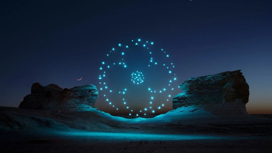 Drone light show illuminating a desert landscape at night, creating a captivating display of glowing lights against the dark sky.