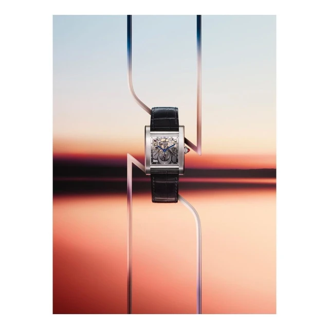 Elegant wristwatch with a black leather band and silver rectangular face, set against a gradient backdrop with geometric lines.