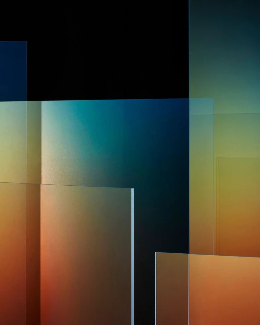 Abstract composition featuring layered translucent panels with a gradient of warm and cool colors against a dark background, creating depth.