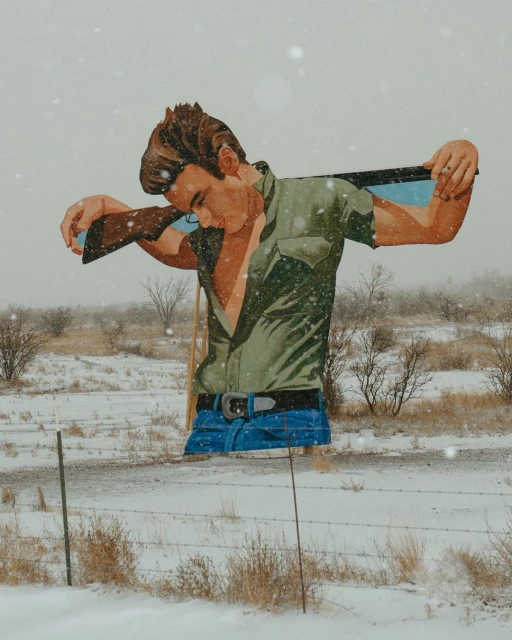 Illustration of a man with a rifle in a snowy field.  The man has brown hair and is wearing a green shirt and blue jeans.