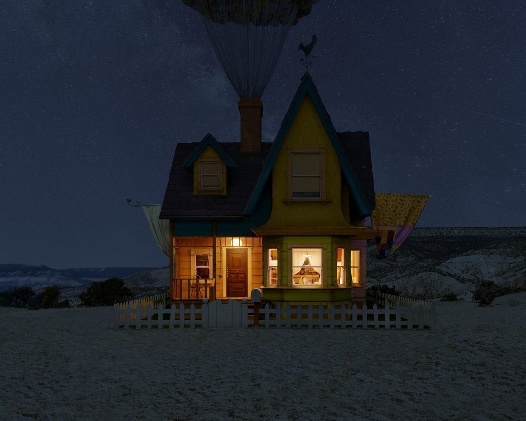 House from 'Up' floats above a snowy field beneath a starry night sky, creating a whimsical and enchanting scene.