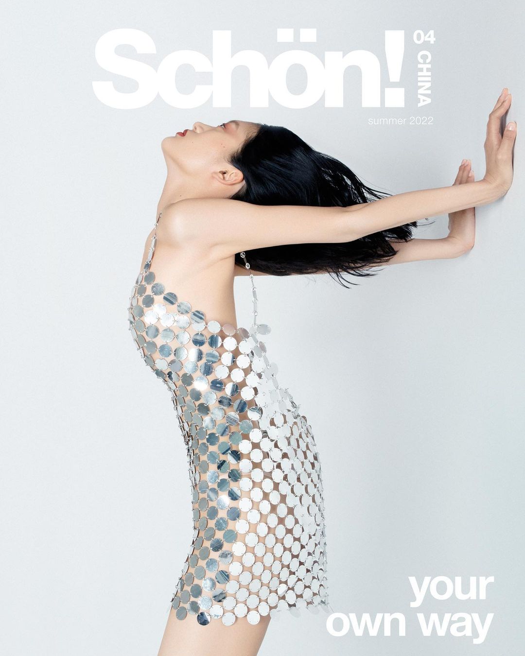 Elegant woman in a shimmering dress poses gracefully against a plain background, featured on the cover of Schön! China Summer 2022.