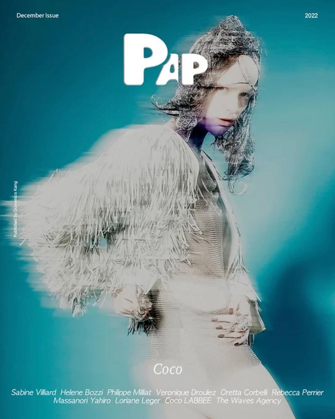 Magazine cover featuring a model in a white fringed outfit against a teal background with PAP logo and publication details.
