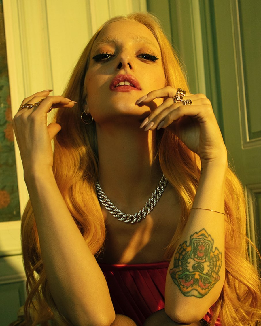 Portrait of a blonde woman with heavy eyeliner and a diamond chain necklace, photographed by Sabine Villiard in Paris.