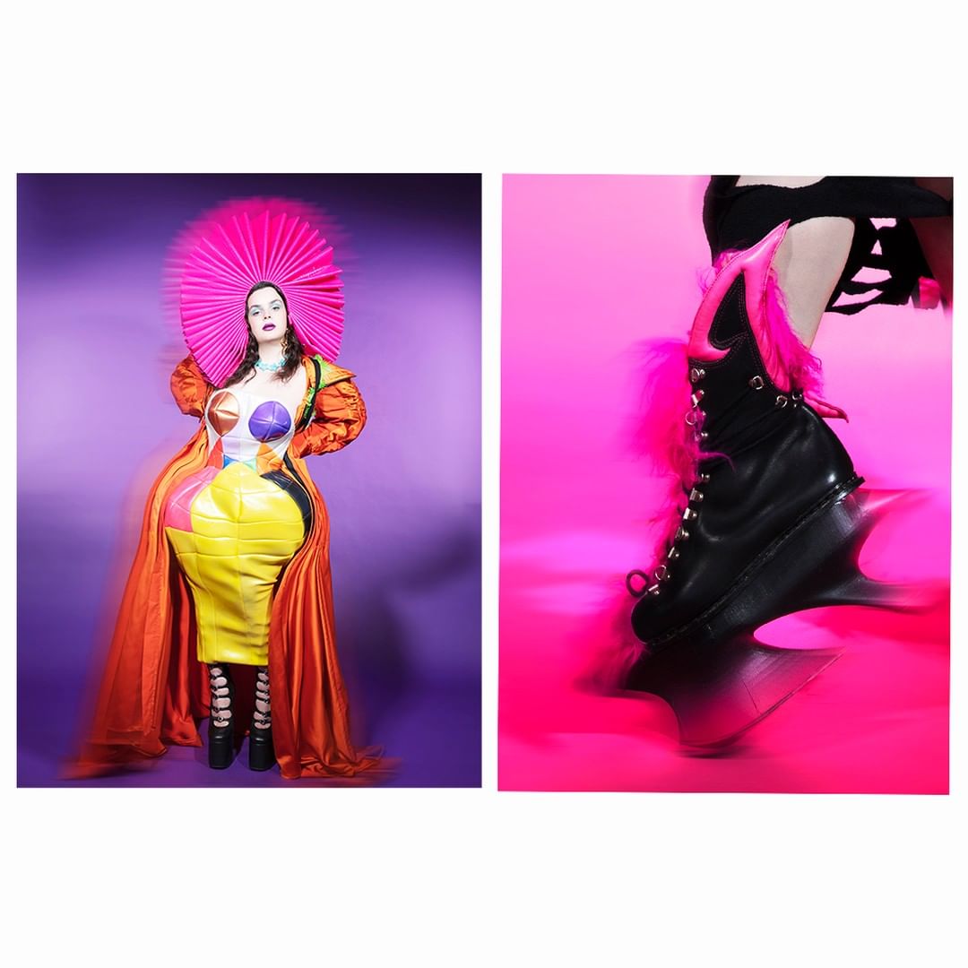 A woman in a colorful costume with a hot-pink halo-like hat poses next to a boot with a futuristic heel on a pink backdrop.