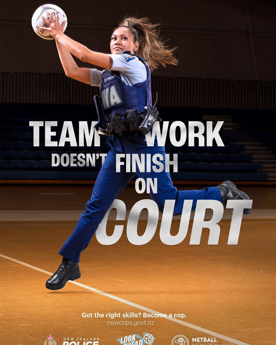 A female police officer is jumping in the air to catch a netball, promoting the idea that teamwork extends beyond the court.