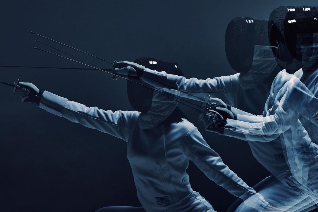 A dynamic action shot captures a fencer in motion, wearing protective gear and wielding a foil, set against a dark, contrasting backdrop.