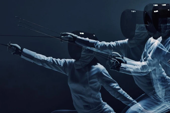 A dynamic action shot captures a fencer in motion, wearing protective gear and wielding a foil, set against a dark, contrasting backdrop.