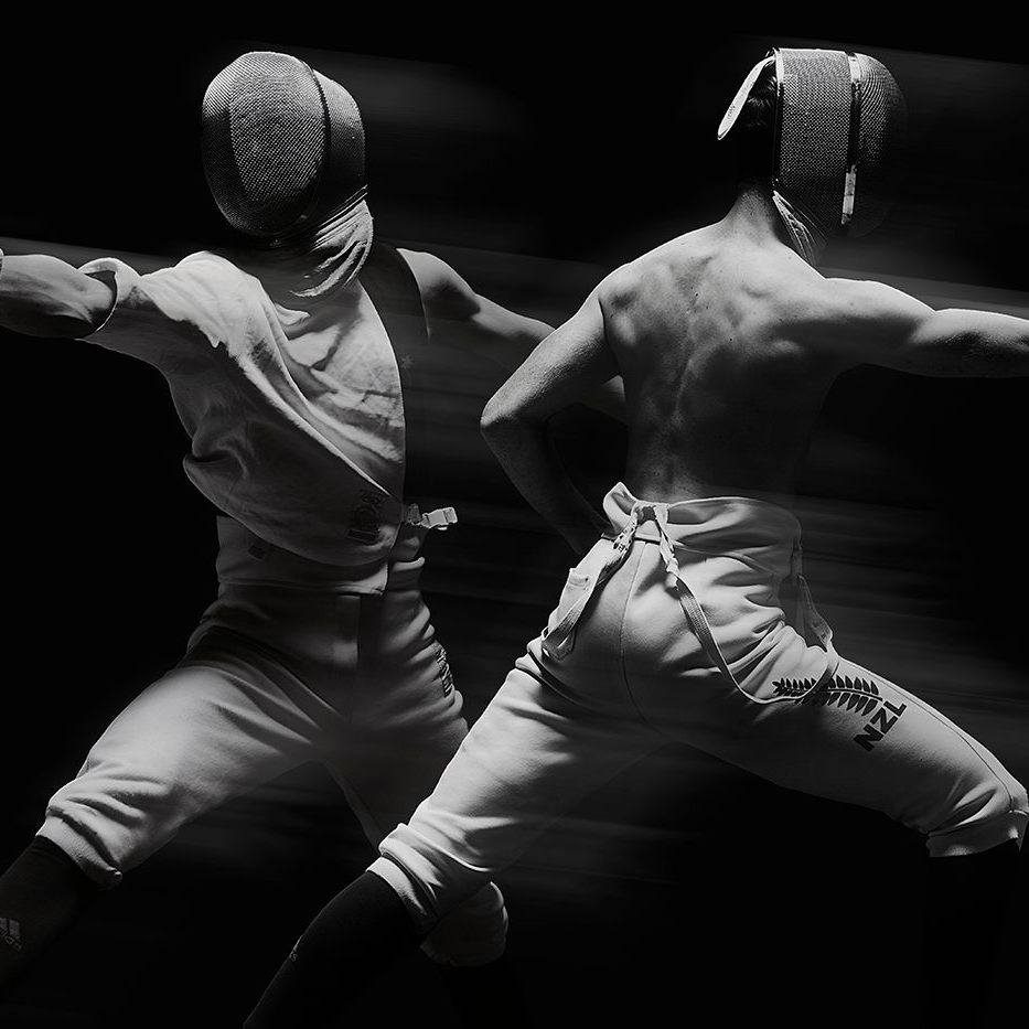 Two fencers with protective gear in a dramatic black and white composition, featuring motion blur, and high contrast, showcasing athletic fencing.