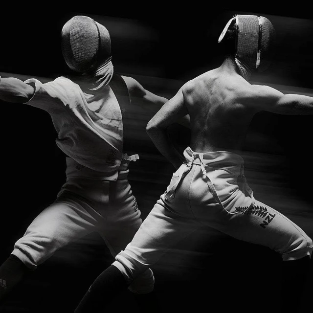 Two fencers with protective gear in a dramatic black and white composition, featuring motion blur, and high contrast, showcasing athletic fencing.