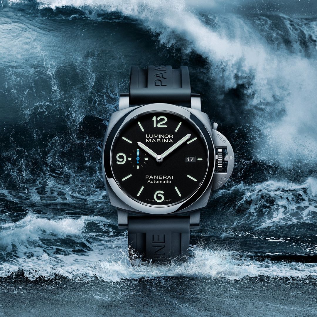 Luxury Panerai Luminor Marina watch featured against a dramatic backdrop of deep blue ocean waves, emphasizing its connection to water.