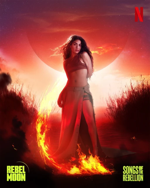 Woman in crop top and skirt poses with fire effect on a sunset-colored movie poster for 'Rebel Moon: Songs of the Rebellion'.