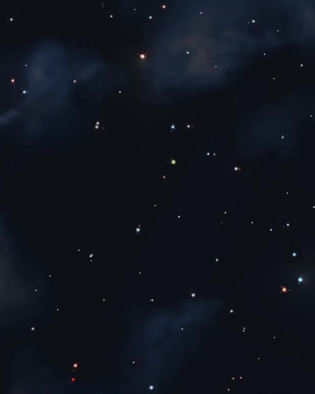 Stars and cosmic clouds against a dark backdrop. The cosmos features a mix of dim and bright stars with subtle cloud formations.