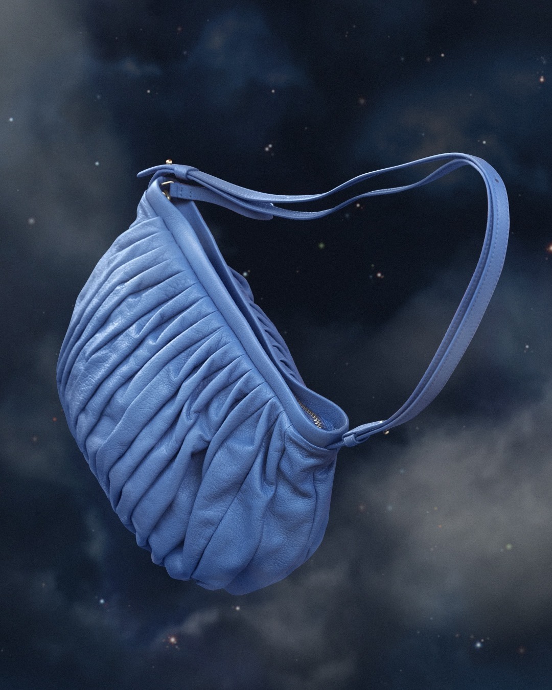 Elegant blue leather handbag with a ruched design and shoulder strap displayed against a dark blue night sky with cloud and star background.