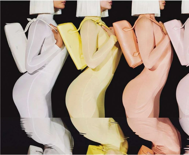 A fashion shot shows four women in pastel body suits and handbags, with their torsos and bags reflected against a black background.