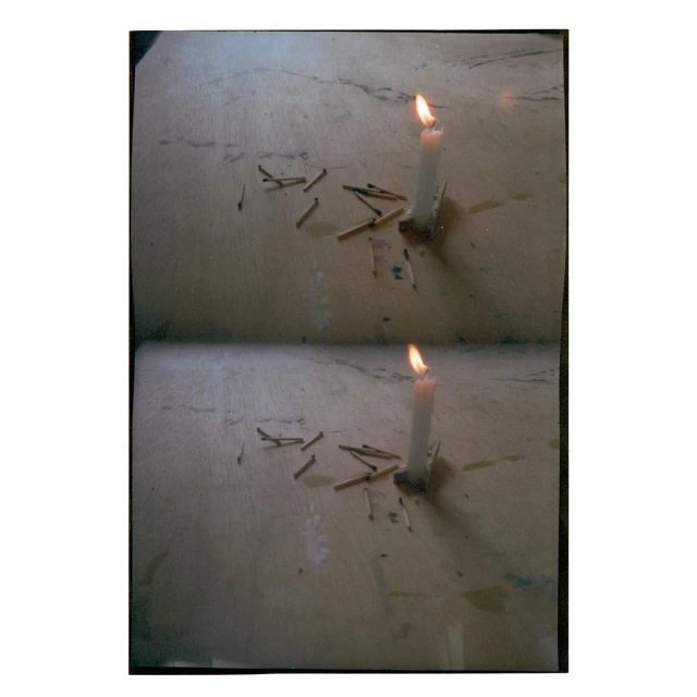 Candle burns on a textured surface with used matches scattered around, duplicated to show two identical scenes in a single frame.