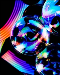 Close-up of translucent spheres reflecting vibrant neon light trails against a black background in an abstract composition.
