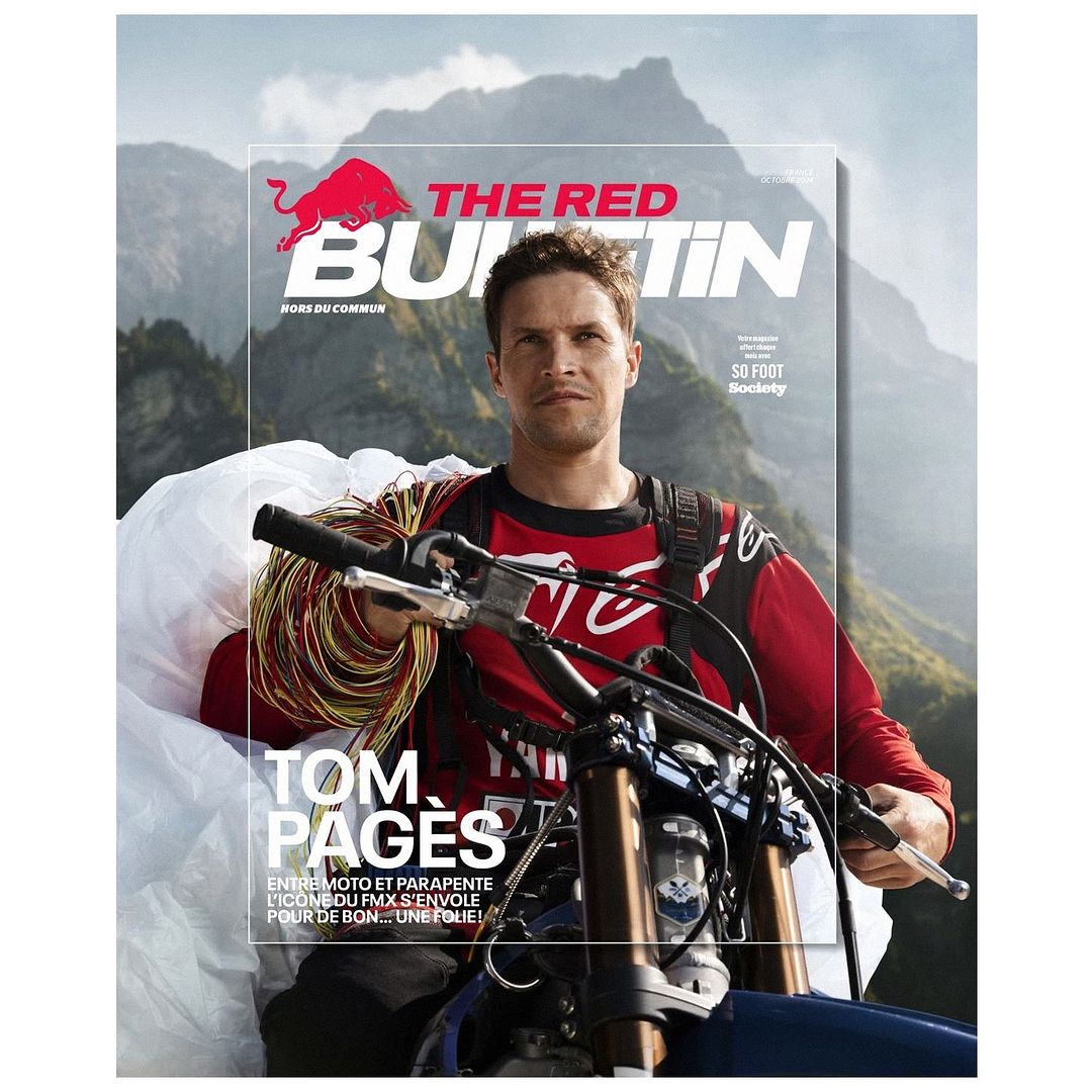 Magazine cover featuring a man on a motorbike with a parachute, set against a backdrop of mountains.