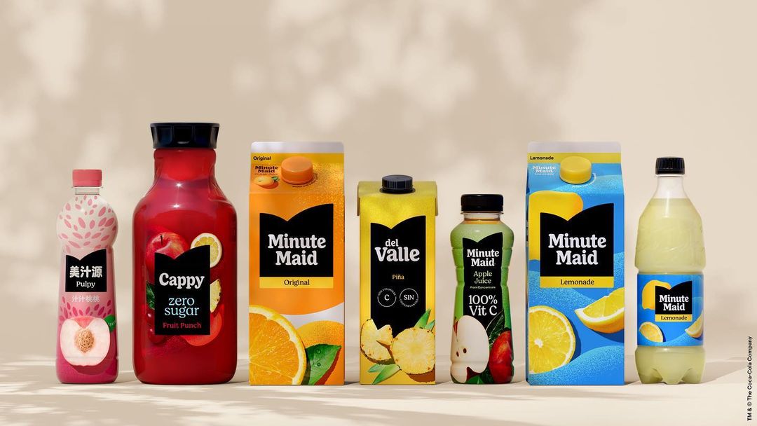 Assortment of Minute Maid and Cappy brand fruit juice beverages in bottles and cartons, lined up against a neutral background.