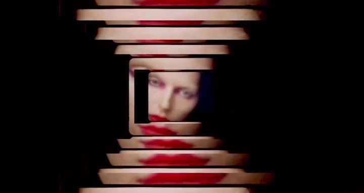 Conceptual image of a woman's face framed by geometric shapes and red accents against a dark background, creating a striking visual.