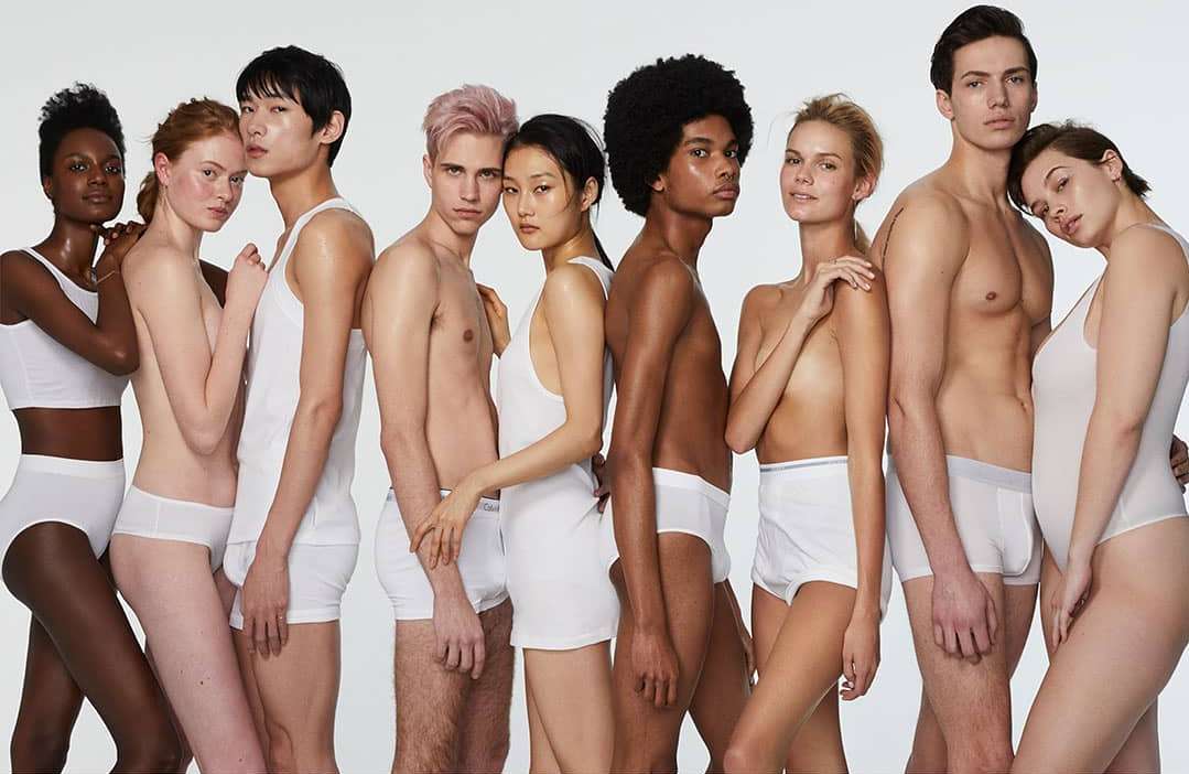 Diverse group of nine models in white underwear posing against a white backdrop, showcasing a variety of body types and skin tones.