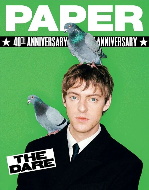 Paper Magazine 40th Anniversary cover featuring a young adult male with two pigeons perched on his head and shoulder against green backdrop.