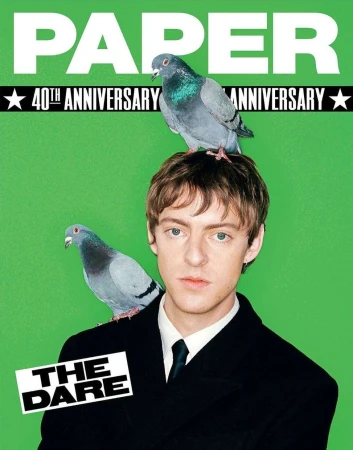 Paper Magazine 40th Anniversary cover featuring a young adult male with two pigeons perched on his head and shoulder against green backdrop.