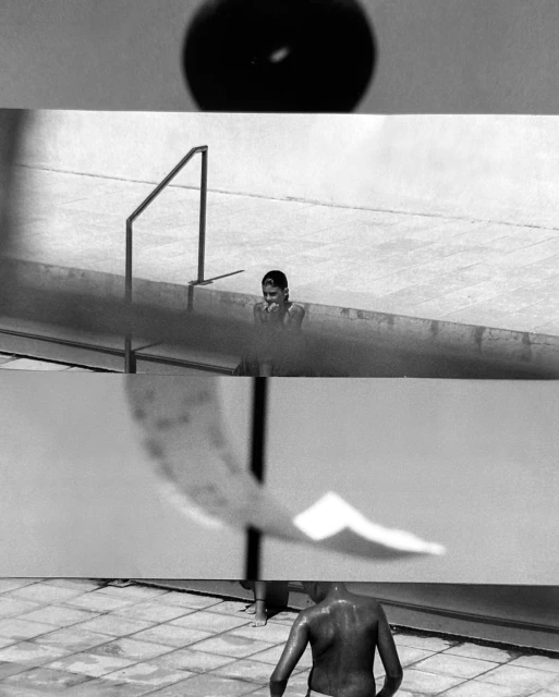 Monochrome image featuring a boy in a pool, with a focus on the interplay of light and shadow, captured with a detailed, textured composition.