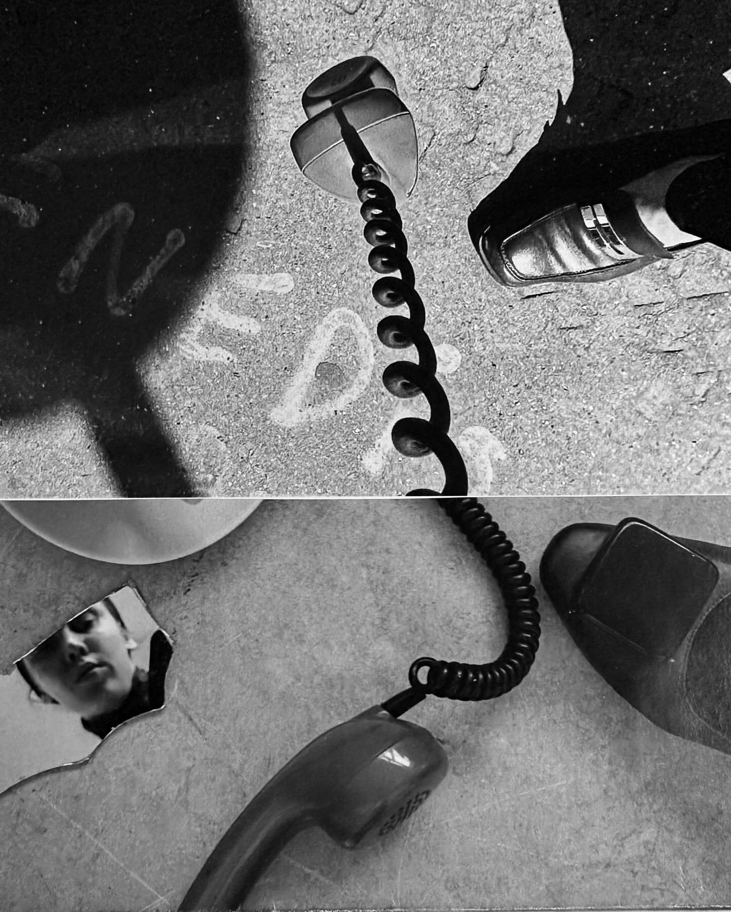 High-angle, grayscale shot of a telephone receiver, shoes, and a person's reflection creating a surreal, dreamlike photographic composition.