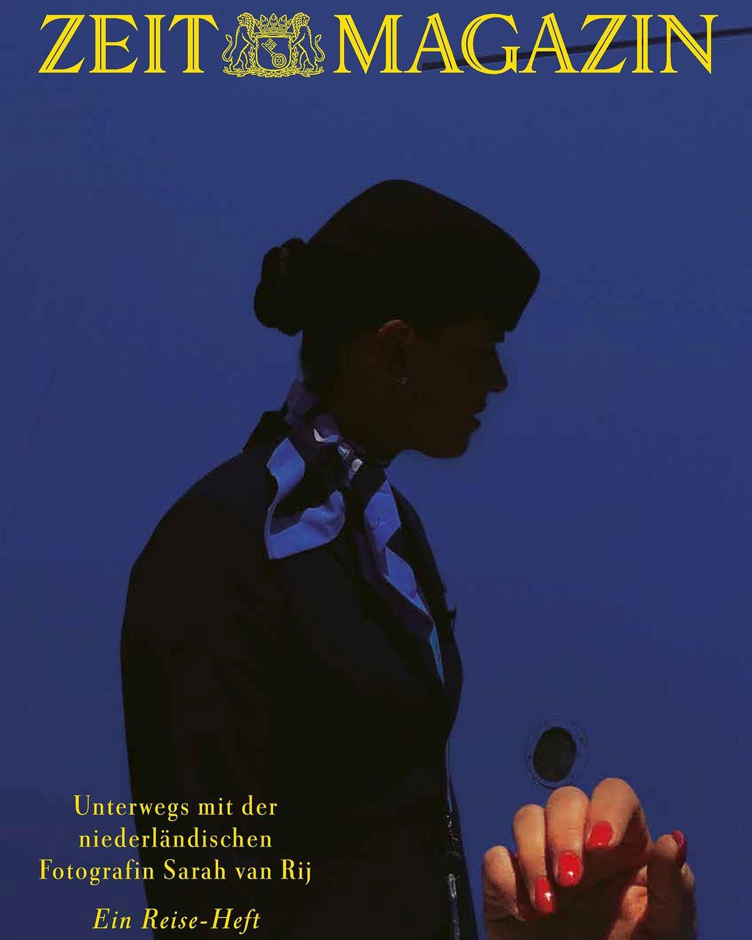 Magazine cover featuring a silhouetted flight attendant against a blue backdrop with magazine text and a hand with red nail polish.