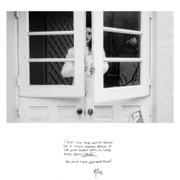 Black and white portrait of a woman peering through the slightly open white double doors of a building.