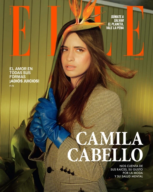 Magazine cover featuring Camila Cabello in a patterned coat and blue gloves, holding a bird of paradise flower, with 'ELLE' masthead.