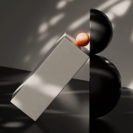 Abstract still life featuring stacked black spheres, a beige block, and a small orange sphere, set against a grey backdrop with lighting effects.