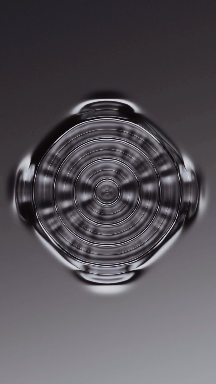 Abstract macro image featuring concentric circles and metallic tones in a futuristic and symmetrical design.