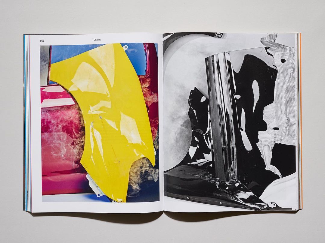 Open book displays abstract art; left page features yellow & pink forms, right page showcases monochrome crumpled foil art.
