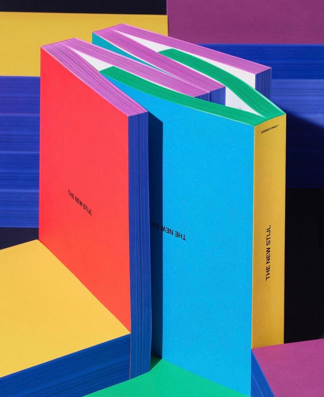 Abstract colorful book arrangement. Bright red, blue, green, yellow and purple books positioned in a geometric layout.