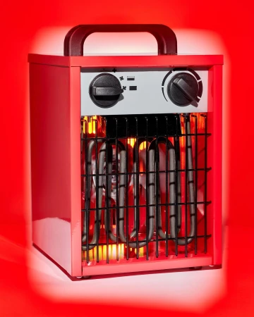 A red portable electric heater with black handle and controls stands against a red background, the heating elements glowing orange.