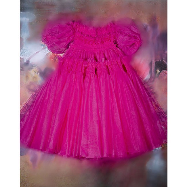 Pink organza dress with puffy sleeves. A whimsical fashion statement with flowing fabric, perfect for a special occasion, with blurred background.