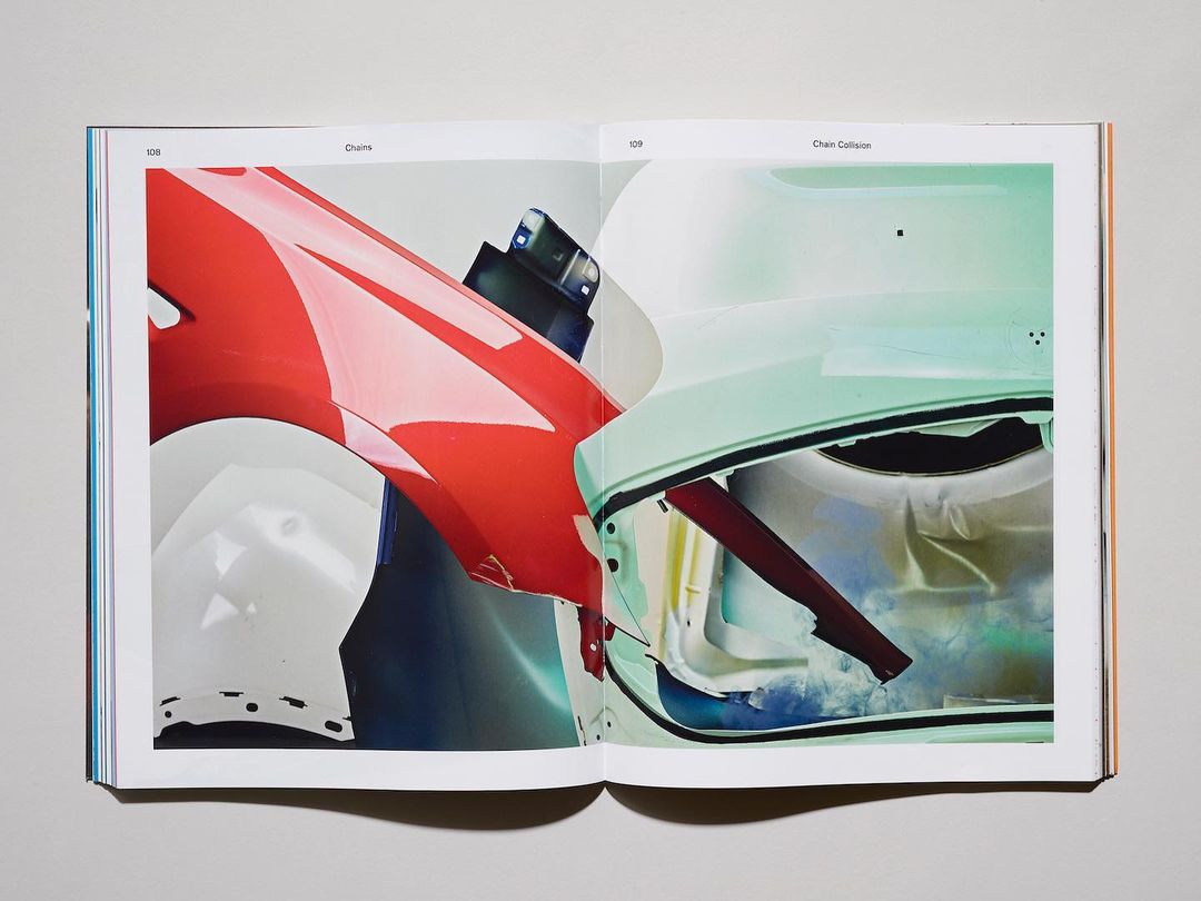 Open magazine featuring a double-page spread of abstract automotive images with bright color gradients, presented against a light gray background.