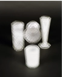 Collection of white and clear glassware objects featuring fine striped patterns arranged on a dark gradient background.