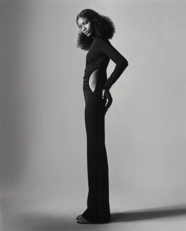 Black and white portrait of a model in a long black fitted dress with side cutout by Scott Trindle in Paris